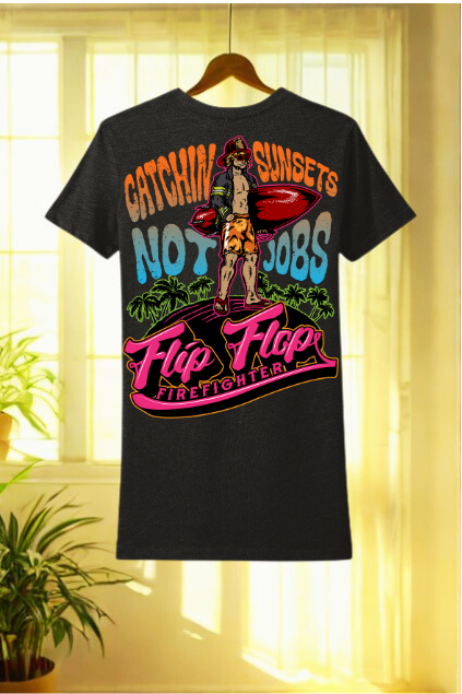 Black t-shirt with colorful graphic and text on a hanger against a light curtain background