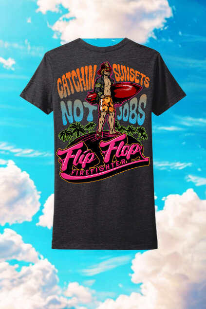 Black t-shirt with colorful graphic design against a blue sky with clouds