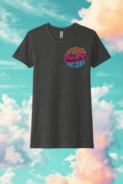 Black t-shirt with colorful text design on a pastel sky and cloud background