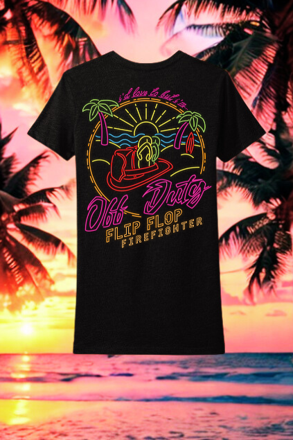 Black t-shirt with colorful graphic design on a beach sunset background