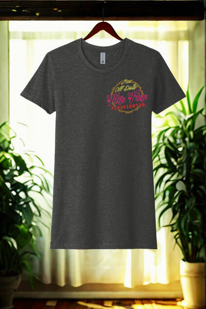 Dark gray t-shirt with colorful graphic design on a hanger against a window and plant background
