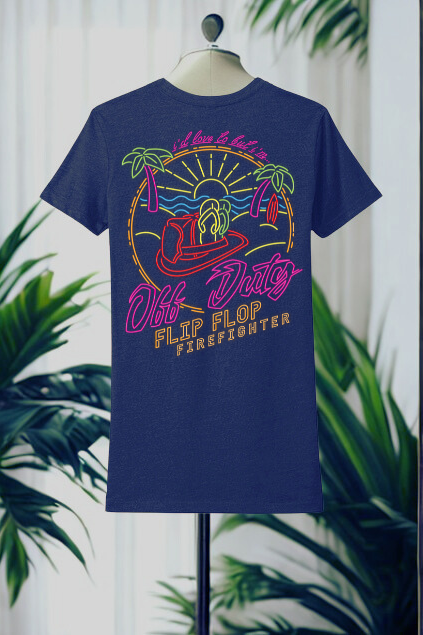 Blue t-shirt with colorful graphic design on a mannequin against a white curtain background