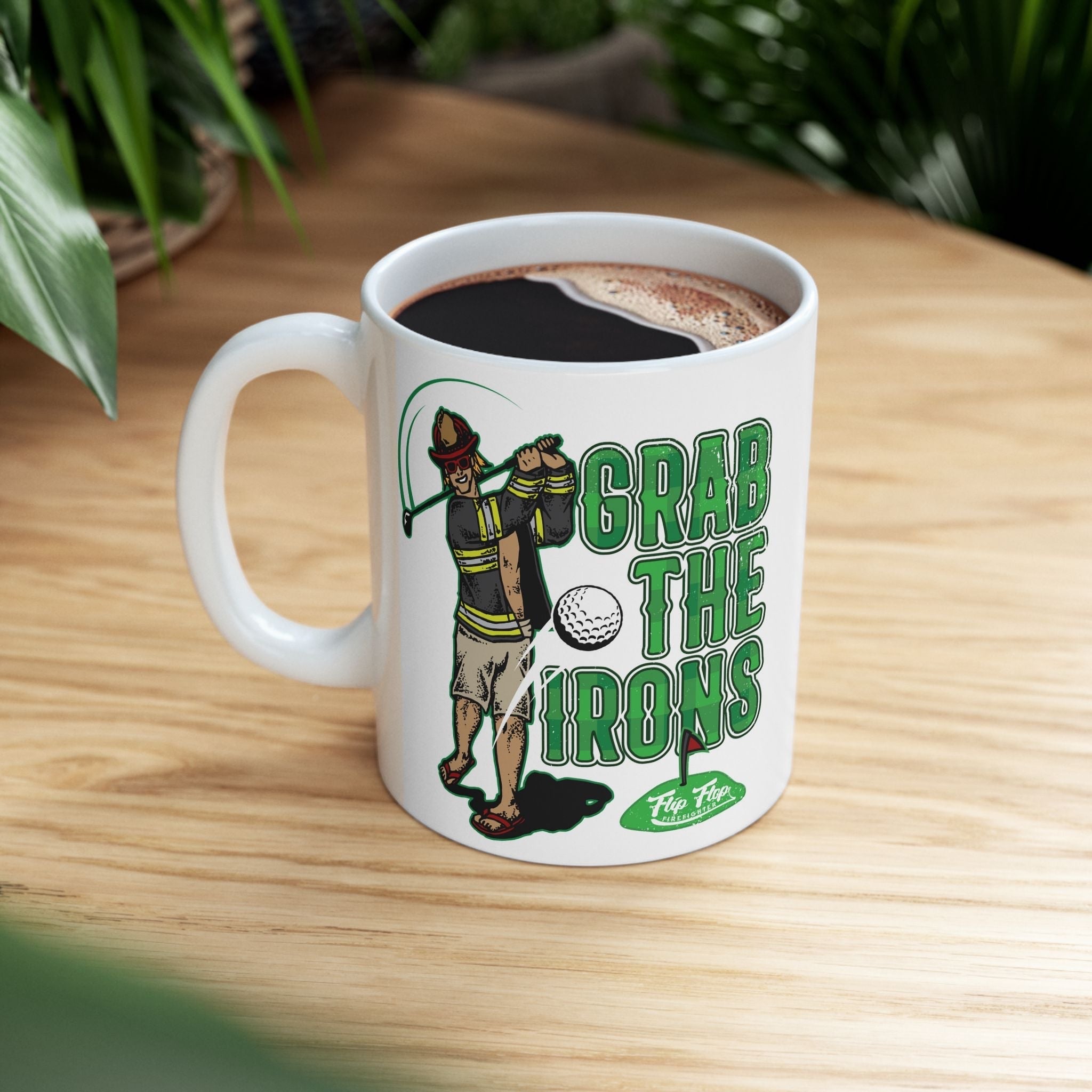 Flip Flop Firefighter white ceramic coffee mug featuring a firefighter golfing graphic and Grab The Irons text.