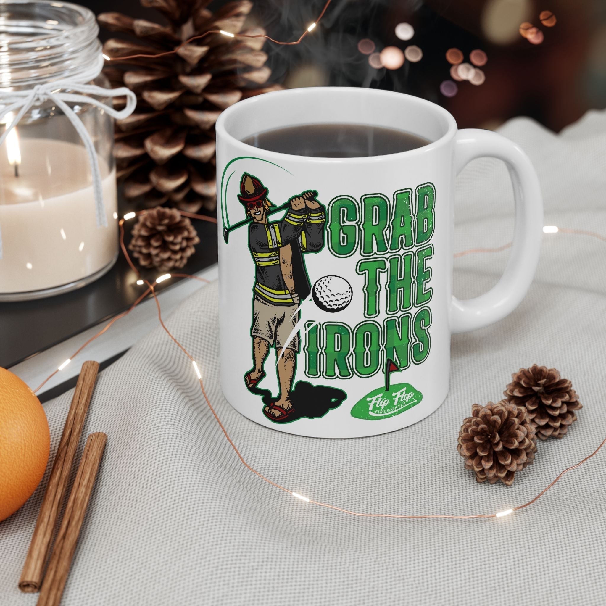 Flip Flop Firefighter white ceramic coffee mug featuring a firefighter golfing graphic and Grab The Irons text.