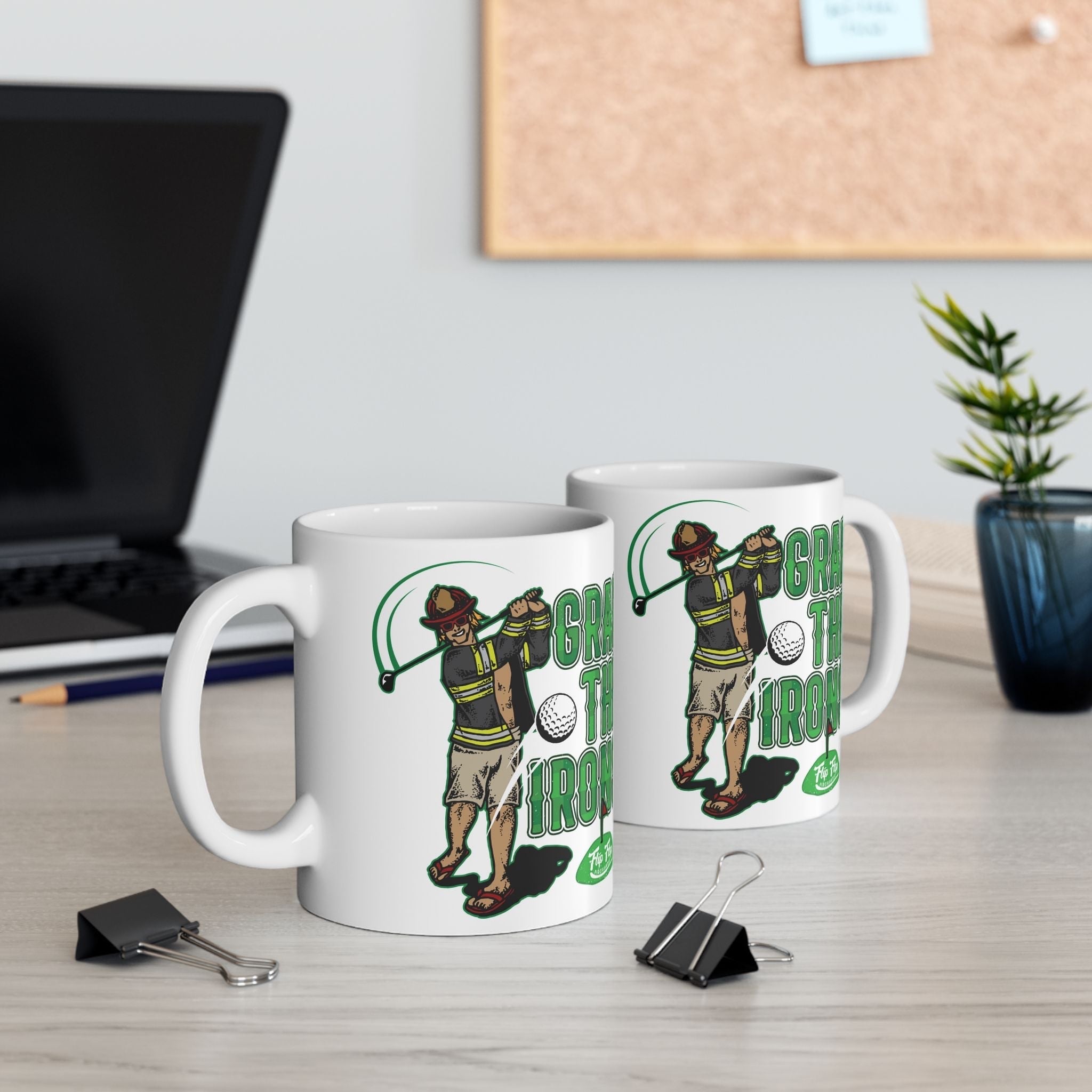 Flip Flop Firefighter white ceramic coffee mug featuring a firefighter golfing graphic on a wooden desk.