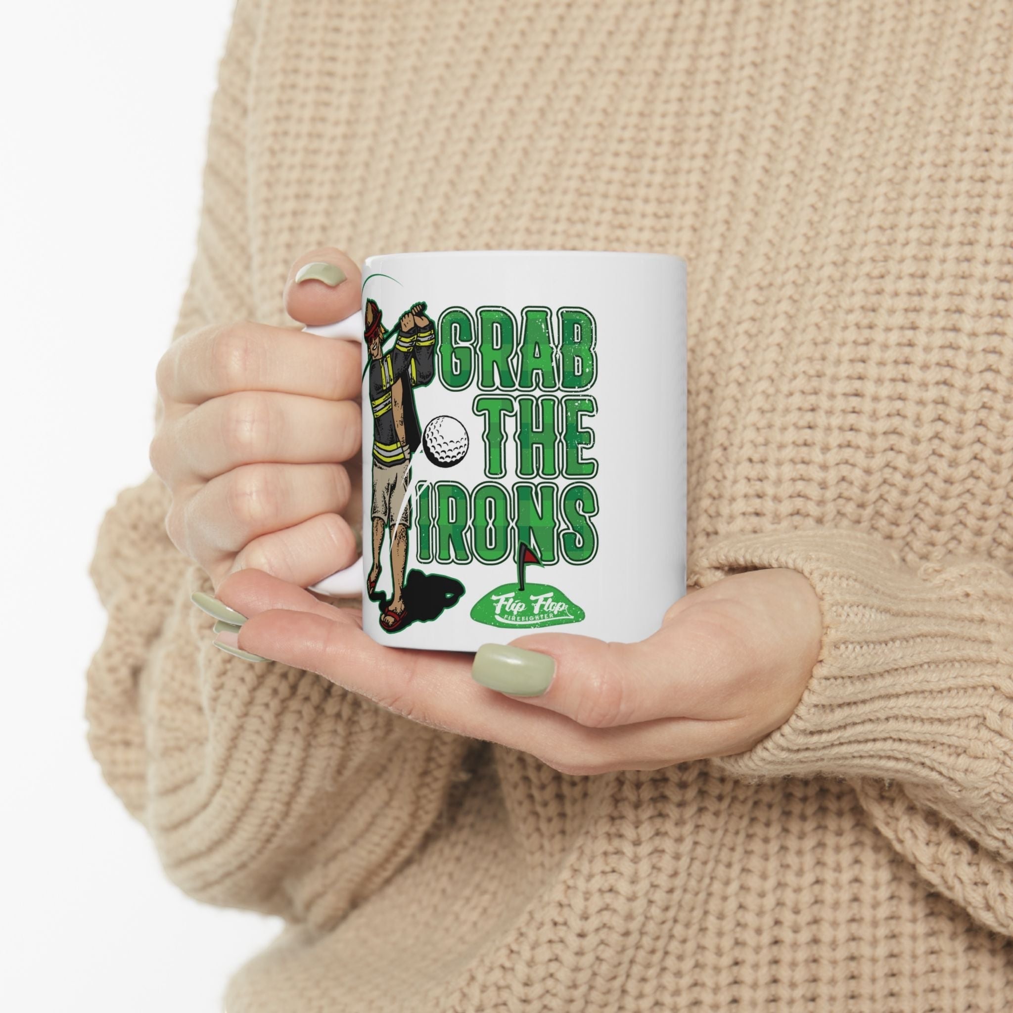 Flip Flop Firefighter white ceramic coffee mug featuring a firefighter golfing graphic and Grab The Irons text.