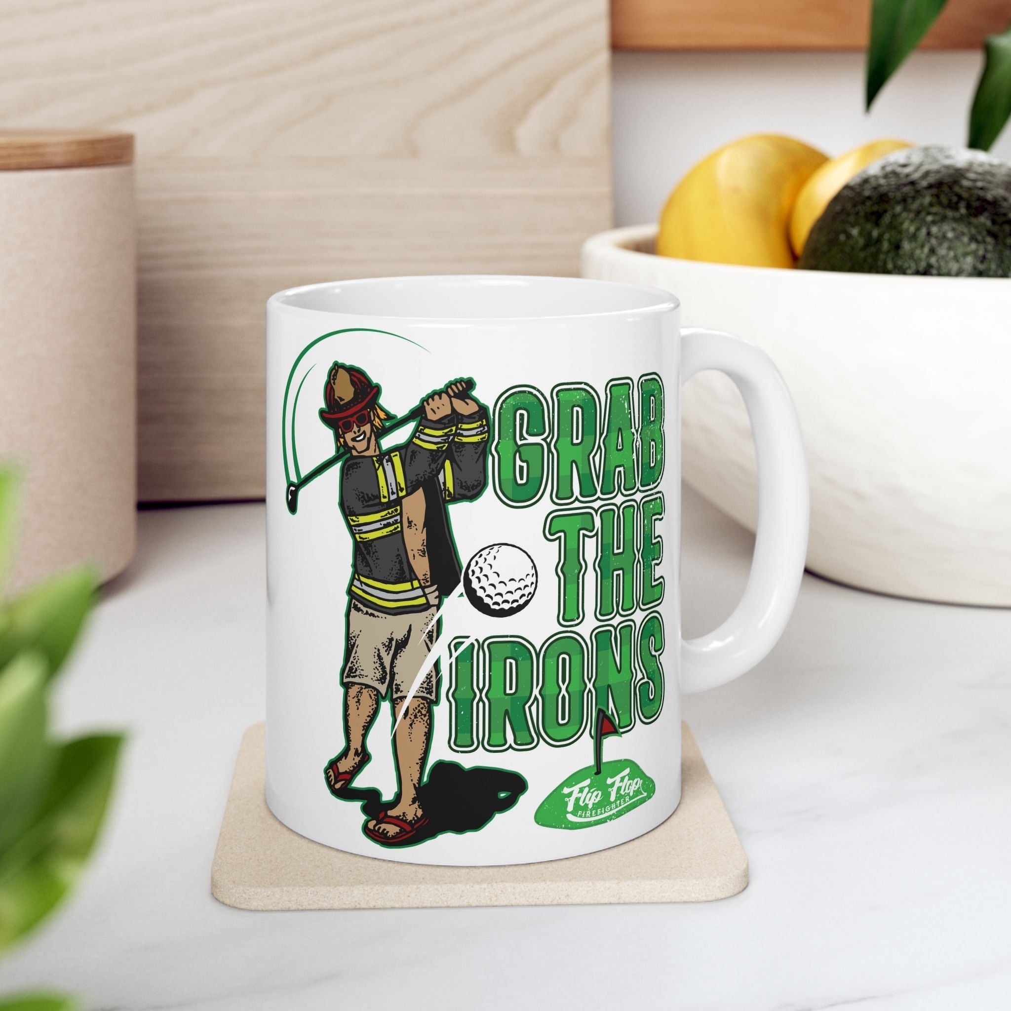 Flip Flop Firefighter white ceramic coffee mug featuring a firefighter golfing illustration and Grab The Irons text.
