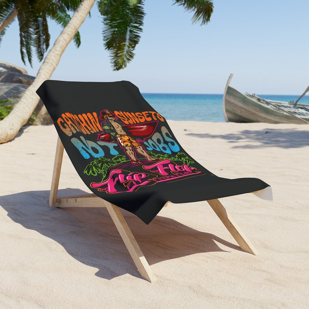 Flip Flop Firefighter beach towel with Catchin’ Sunsets Not Jobs graphic on a lounge chair at a sunny tropical beach.