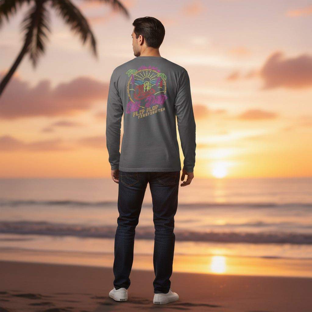 Flip Flop Firefighter long sleeve grey shirt with neon beach graphic worn by a man on a beach at sunset