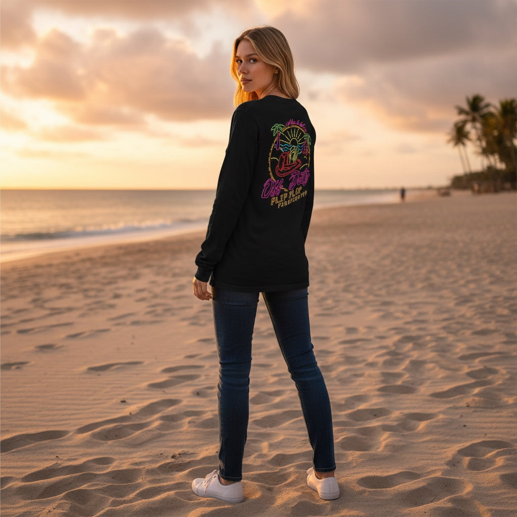 Flip Flop Firefighter long sleeve shirt with neon graphic on back, worn by a woman on a beach at sunset.