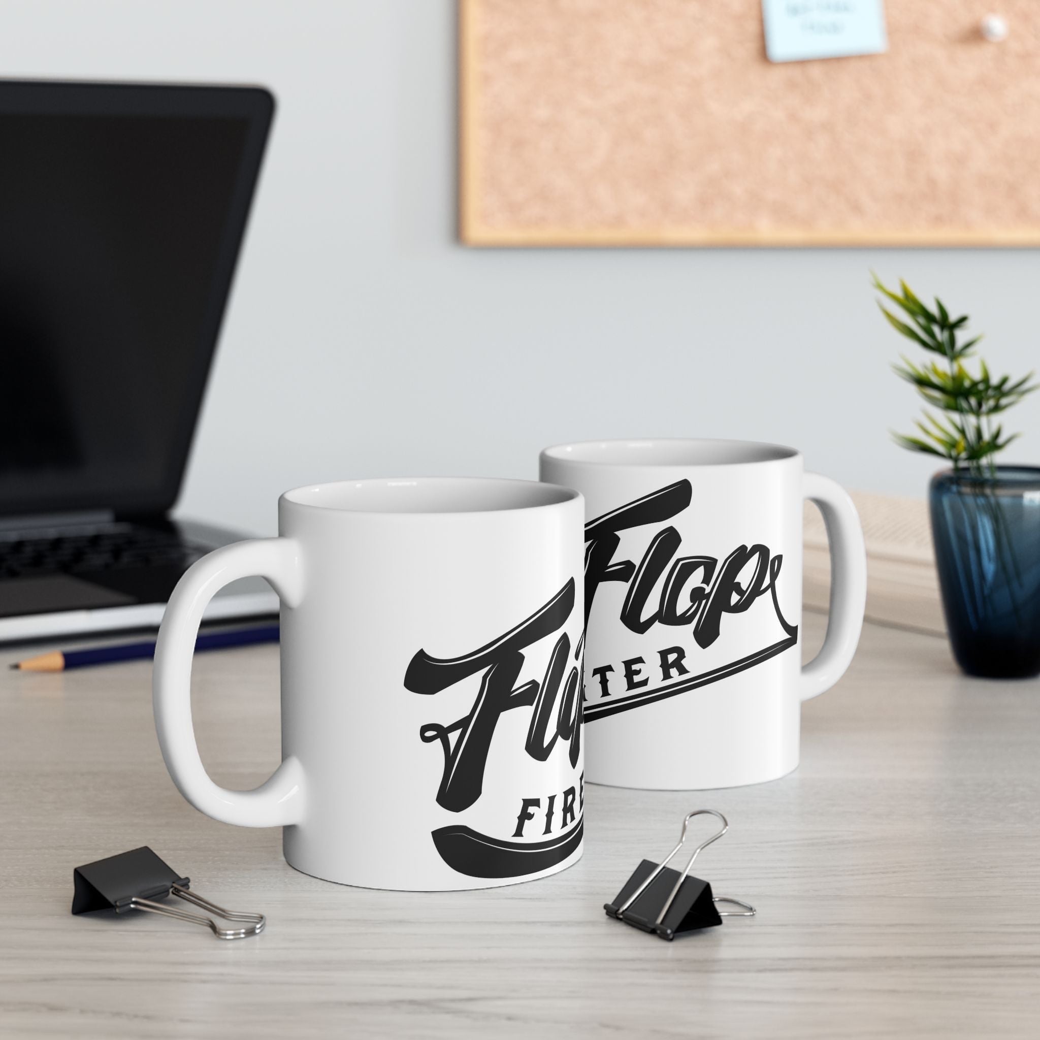Flip Flop Firefighter white ceramic coffee mugs with black logo on a desk with a laptop and office supplies.