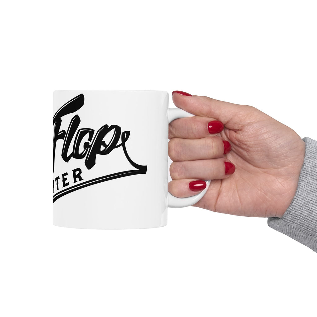 Flip Flop Firefighter white ceramic coffee mug with black logo held by a hand with red nail polish
